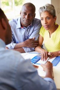 Mature Couple Meeting With Attorney At Home for estate planning.